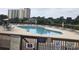 Relaxing community pool area with plenty of lounge chairs and umbrellas at 175 Saint Clears Way # 23A, Myrtle Beach, SC 29572