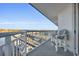 Open-air balcony showcasing ample seating, and a distant view of bridges and trees at 2100 Sea Mountain Hwy. # 630, North Myrtle Beach, SC 29582