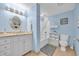 Bathroom with light blue walls, granite vanity and tub shower at 2100 Sea Mountain Hwy. # 630, North Myrtle Beach, SC 29582