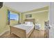 Bright bedroom with hardwood floors, a comfortable bed, and natural light from a large window at 2100 Sea Mountain Hwy. # 630, North Myrtle Beach, SC 29582