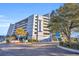 Low angle view of the condo exterior, showing the building, balconies, and surrounding trees at 2100 Sea Mountain Hwy. # 630, North Myrtle Beach, SC 29582