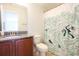 Bathroom with granite countertop, wooden cabinet, and ocean-themed shower curtain at 2117 Mirabel Ct., North Myrtle Beach, SC 29582