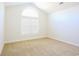 Bedroom with vaulted ceiling, carpet flooring, and an arched window at 2117 Mirabel Ct., North Myrtle Beach, SC 29582