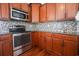 Well-equipped kitchen featuring granite counters and wood cabinets at 2117 Mirabel Ct., North Myrtle Beach, SC 29582