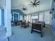 Comfortable clubhouse patio with seating, ceiling fans, and outdoor views at 2155 Gooseberry Way, Longs, SC 29568