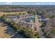 Wide aerial shot of a townhome community with beautiful landscaping, pond, and surrounding greenery at 2404 Thoroughfare Dr. # 2404, North Myrtle Beach, SC 29582