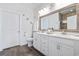 Well-lit bathroom features double sinks, wooden floors, and a beautifully framed mirror at 2404 Thoroughfare Dr. # 2404, North Myrtle Beach, SC 29582