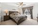 Bedroom with a wooden bed frame and patterned bedding next to a window with patterned valance at 2404 Thoroughfare Dr. # 2404, North Myrtle Beach, SC 29582