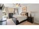 A stylish bedroom with a black bed frame, neutral bedding, elegant curtains, and tasteful artwork at 2404 Thoroughfare Dr. # 2404, North Myrtle Beach, SC 29582