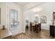 Cozy dining area features neutral tones, stylish chandelier, and views of the outdoors at 2404 Thoroughfare Dr. # 2404, North Myrtle Beach, SC 29582