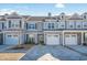 Gray siding three-story townhome with two-car garage and landscaping at 2404 Thoroughfare Dr. # 2404, North Myrtle Beach, SC 29582