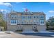 Three-story townhome with gray siding, two-car garage, and landscaping at 2557 Pete Dye Dr. # 1102, North Myrtle Beach, SC 29582