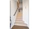 Beige carpeted staircase with dark wood railing at 2557 Pete Dye Dr. # 1102, North Myrtle Beach, SC 29582