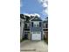 A two-story townhome exterior boasts blue siding, a white garage door, and neat landscaping at 261 Christiana Ln. # B, Myrtle Beach, SC 29579