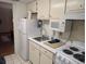 Simple kitchen with microwave, stove and refrigerator at 2611 Ocean Blvd. S # 305, Myrtle Beach, SC 29577