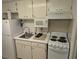 Small kitchen with white cabinets and appliances at 2611 Ocean Blvd. S # 305, Myrtle Beach, SC 29577