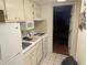 Small, well-equipped kitchen with white cabinets at 2611 Ocean Blvd. S # 305, Myrtle Beach, SC 29577