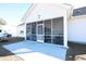 House exterior showcasing a screened porch and concrete patio at 262 Ole Maple St., Loris, SC 29569