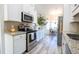 Modern kitchen with white cabinets, granite countertops, and stainless steel appliances at 262 Ole Maple St., Loris, SC 29569