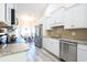 Modern kitchen with white cabinets, granite countertops, and stainless steel appliances at 262 Ole Maple St., Loris, SC 29569