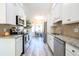 Modern kitchen with white cabinets, granite countertops, and stainless steel appliances at 262 Ole Maple St., Loris, SC 29569