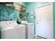 Bright laundry room with white washer and dryer, and beach-themed decor at 262 Ole Maple St., Loris, SC 29569