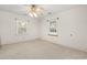 Simple bedroom with carpet, ceiling fan, and two windows at 316 N Highland Ave., Myrtle Beach, SC 29577