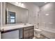 Modern bathroom with dark vanity, large mirror, and a bathtub with a shower at 352 High Falls Dr., Conway, SC 29526