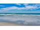 Calm ocean view with gentle waves lapping on the sandy shore under a bright sky at 352 High Falls Dr., Conway, SC 29526