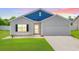 Inviting home with manicured lawn, attached garage, and a welcoming front entrance offers both comfort and style at 352 High Falls Dr., Conway, SC 29526