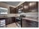Updated kitchen featuring granite countertops, stainless steel appliances, and dark wood cabinets at 352 High Falls Dr., Conway, SC 29526