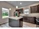 Modern kitchen with granite countertops, dark cabinets, stainless steel appliances, and an island at 352 High Falls Dr., Conway, SC 29526