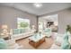 Inviting living room features bright, airy space with white furniture, blue accents and seamless flow into the kitchen at 352 High Falls Dr., Conway, SC 29526