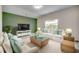 Bright and airy living room with a green accent wall and lots of comfortable seating at 352 High Falls Dr., Conway, SC 29526