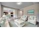 Open living room with white sofas and a view of the kitchen at 352 High Falls Dr., Conway, SC 29526