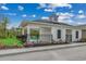 Exterior of community pool house featuring white columns, black iron fence, and blooming flowers at 352 High Falls Dr., Conway, SC 29526