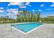 Community pool with surrounding greenery and a pond in the background at 352 High Falls Dr., Conway, SC 29526