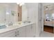 Bathroom with double vanity and view into bedroom at 402 Ocean Pointe Ct., North Myrtle Beach, SC 29582