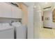 Convenient laundry room with washer, dryer, and storage cabinets at 402 Ocean Pointe Ct., North Myrtle Beach, SC 29582