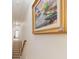 Elegant staircase with a large framed painting on the wall at 402 Ocean Pointe Ct., North Myrtle Beach, SC 29582