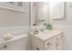 Bright bathroom with a white vanity, framed mirror, and coastal-themed decor at 4384 Daphne Ln. # H, Murrells Inlet, SC 29576