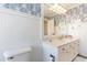 Bathroom with vanity, large mirror, and blue leaf wallpaper at 4384 Daphne Ln. # H, Murrells Inlet, SC 29576