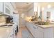 Bright eat-in kitchen, featuring white cabinetry, stainless steel appliances, and mosaic backsplash at 4384 Daphne Ln. # H, Murrells Inlet, SC 29576