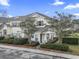 Two-story townhome with light yellow siding, landscaping, and a paved driveway at 4432 Montrose Ln. # H, Myrtle Beach, SC 29579