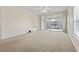 Living room with balcony access and neutral carpeting at 4432 Montrose Ln. # H, Myrtle Beach, SC 29579