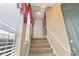 View of staircase leading to the second floor with neutral decor at 4432 Montrose Ln. # H, Myrtle Beach, SC 29579