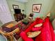 Cozy living room with red sofa, wicker chairs, and oriental rug at 4505 S Ocean Blvd. S # 1-E, North Myrtle Beach, SC 29582