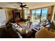 Relaxing living room with ocean view and leather furniture at 4505 S Ocean Blvd. S # 1-E, North Myrtle Beach, SC 29582