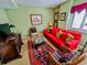 Living room with red sofa, wicker chairs, and a view at 4505 S Ocean Blvd. S # 1-E, North Myrtle Beach, SC 29582