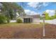 Inviting backyard featuring a screened-in porch, green lawn, trees, and charming birdhouse at 5933 Rahnavard Blvd., Myrtle Beach, SC 29588